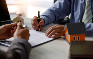 Image depicting a property manager organizing paperwork in an office environment